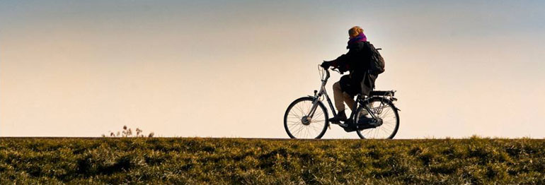 person cycling in a field